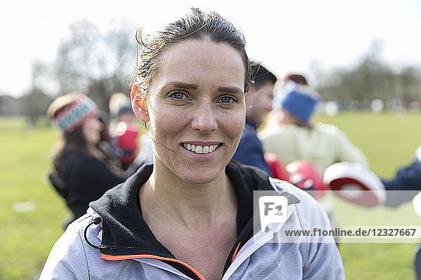 Portrait confident  smiling woman exercising in park