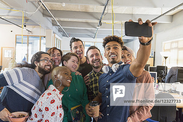 Creative business team taking selfie in office