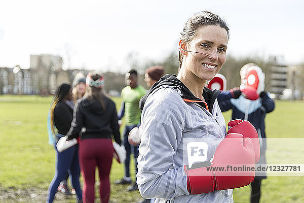 Portrait smiling  confident woman boxing in park