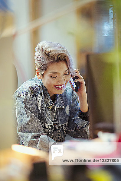 Smiling young woman talking on smart phone