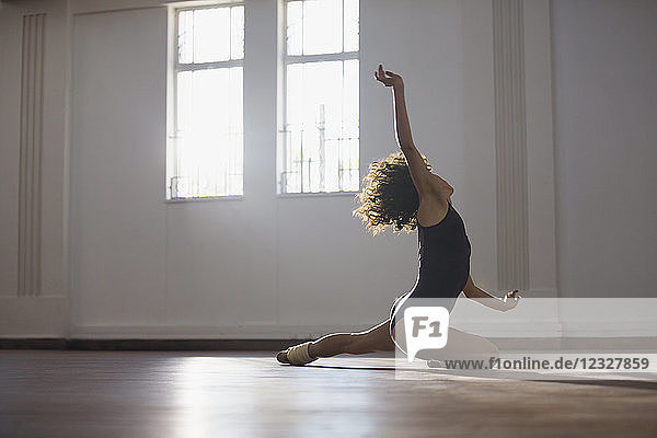 Graceful young female dancer practicing in dance studio