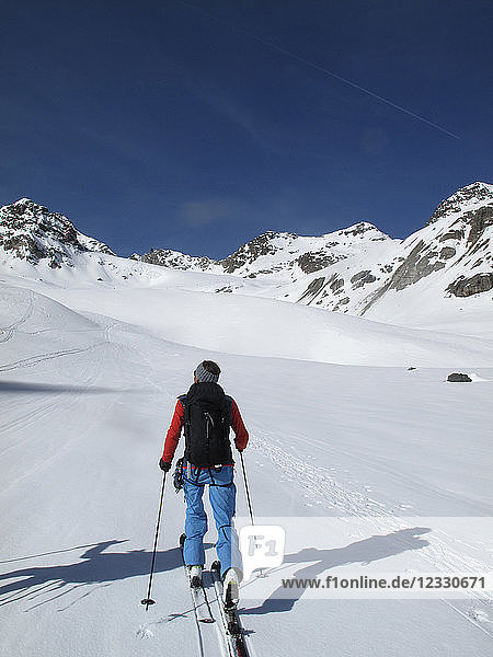 AUSTRIA  Tyrol  Silvretta mountain range  a lonely cross-country skier is hiking towards the Jamtal Joch pass