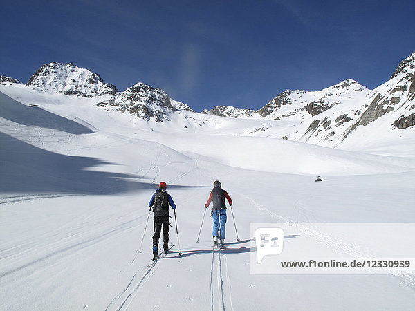 AUSTRIA  Tyrol  Silvretta mountain range  2 cross-country skiers are hiking towards the Jamtal Joch pass