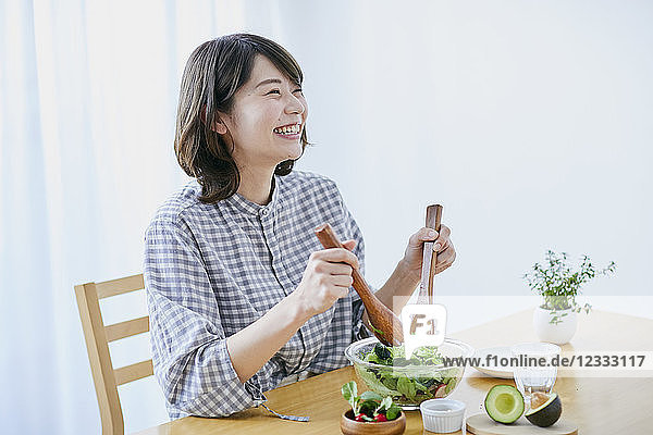 Young Japanese woman eating salad