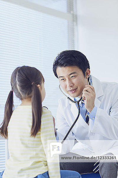 Japanischer Arzt mit einem Patienten in seinem Studio