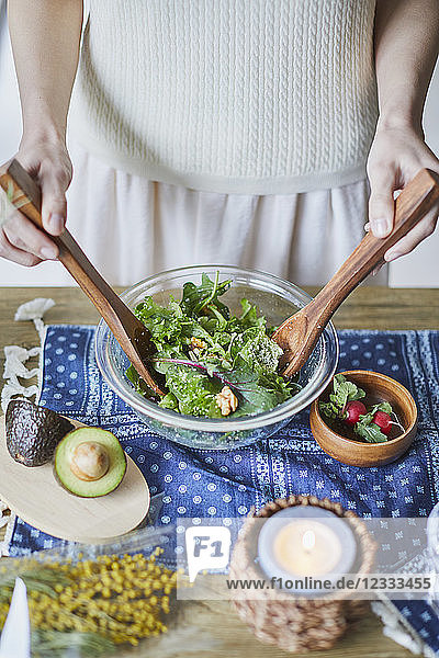 Young Japanese woman preparing salad