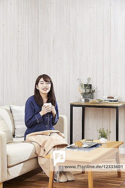 Japanese woman eating in a pajamas