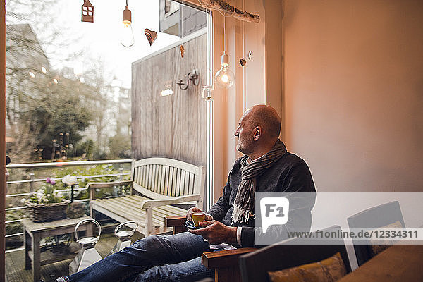 Senior man sitting at home  drinking coffee