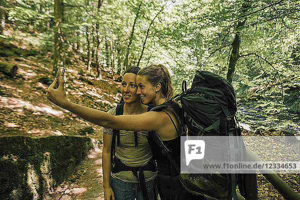 Two young women on a hiking trip taking a selfie