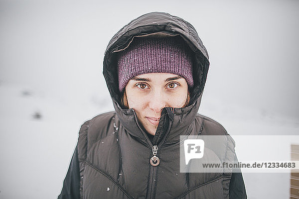 Austria  Kitzbuehel  portrait of smiling young woman in winter