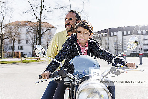 Father and son on a motorbike