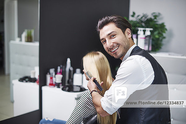 Portrait of smiling hairdresser at work