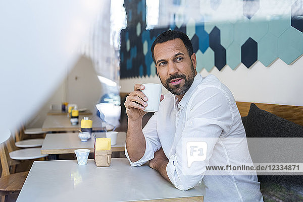 Man drinking coffee in a cafe