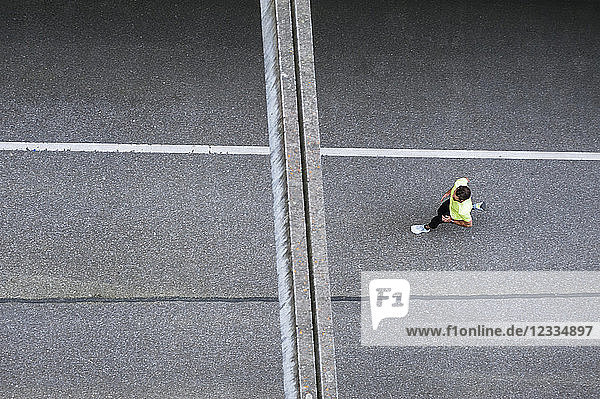 Top view of man running on a street