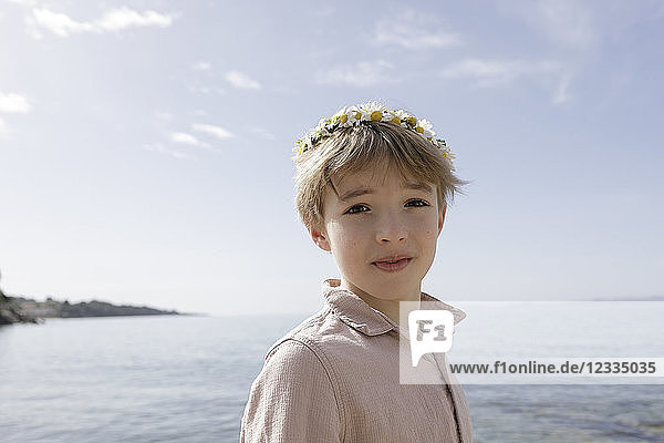 Portrait of boy wearing flowers
