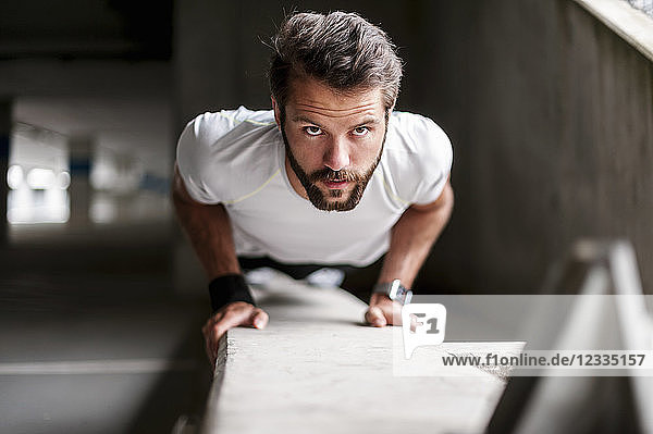Portrait of man doing push-ups