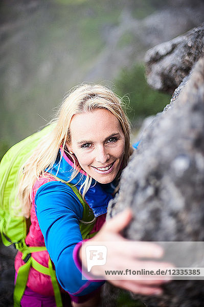 Austria  Salzburg State  Filzmoos  Female hiker climbing on rock
