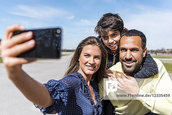 Happy family taking a selfie outdoors