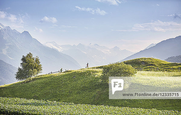 Austria  Tyrol  Patsch  athletes running in mountainscape