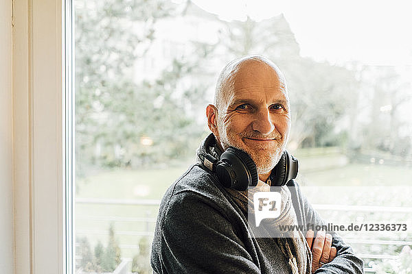 Portrait of a smiling senior man with headphones