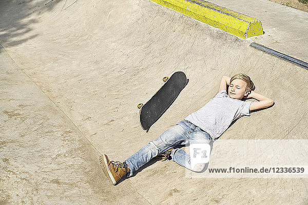 Boy relaxing in skatepark