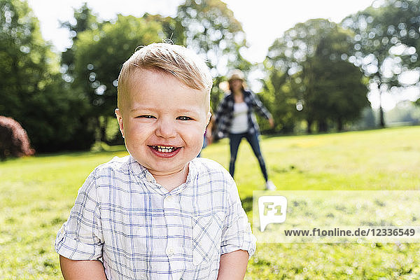 Portrait of happy boy with motherin a park