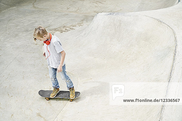 Boy with headphones on skateboard  skateboarding