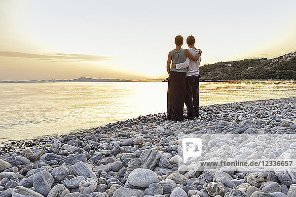 Greece  Pelion  couple enjoying at sunset at beach