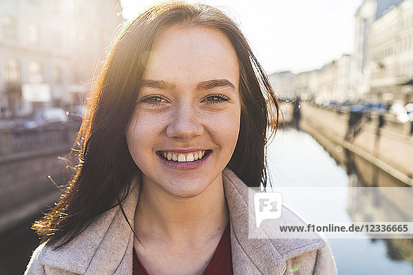 Portrait of happy young woman in the city