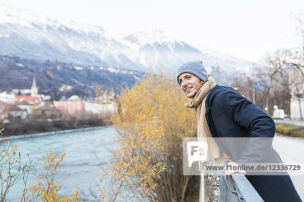 Austria  Innsbruck  portrait of smiling young man looking at distance