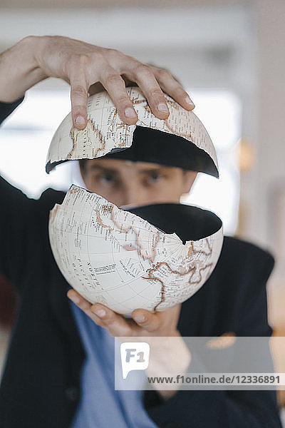 Man holding broken globe