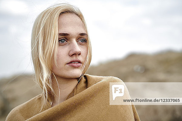 Portrait of blond young woman on the beach