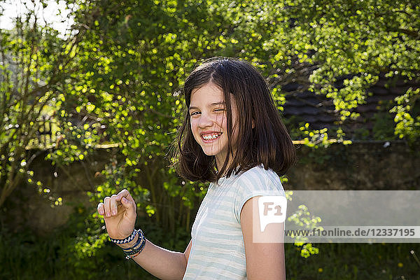 Portrait of laughing girl in the garden