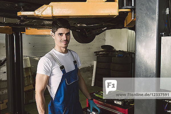 Portrait of smiling mechanic in his workshop