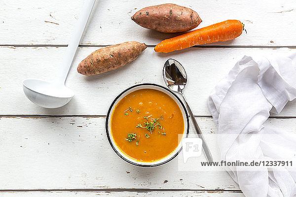 Bowl of sweet potato carrot soup garnished with cress