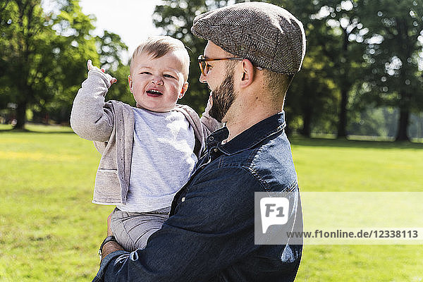 Happy father carrying son in a park
