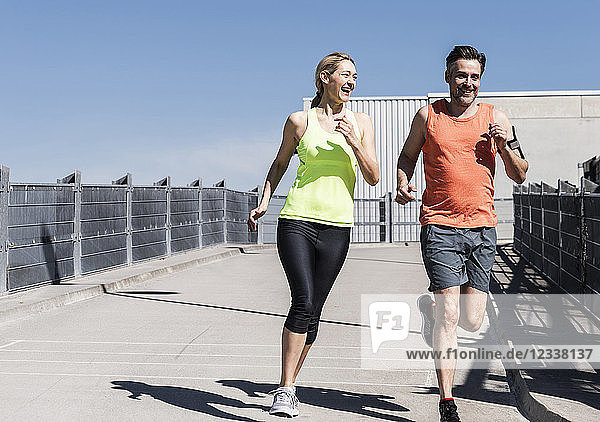 Fit couple jogging in the city