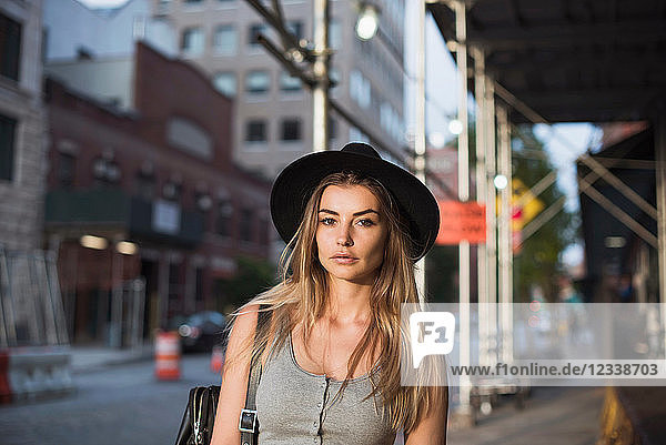 Portrait of woman wearing hat looking at camera  New York  USA