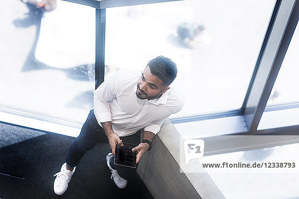 Young man using digital tablet in office