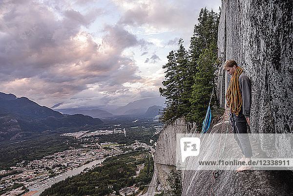 Young male climber standing barefoot on bellygood ledge  The Chief  Squamish  Canada
