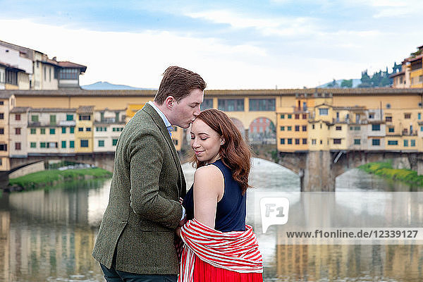 Young man kissing woman  Ponte Vecchio  the Old Bridge  Florence  Toscana  Italy