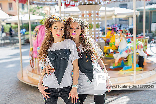 Fashion blogger twins in front of carousel  Mantova  Lombardia  Italy