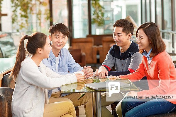 Young men and women in the coffee shop