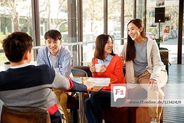 Young men and women in the coffee shop