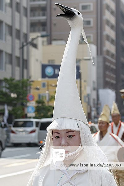 A heron hooded dancer walks towards Sensoji Temple during the Daigyoretsu or Large Parade of Sanja Matsuri Festival in Asakusa on May 18  2018  Tokyo  Japan. The Daigyoretsu Parade is a large procession of priest  city officials  musicians  geishas and dancers dressing Edo Period costumes through Asakusa streets until Sensoji Temple. This is one of the Three Great Shinto Festivals in Tokyo  that is held on the third weekend of May.
