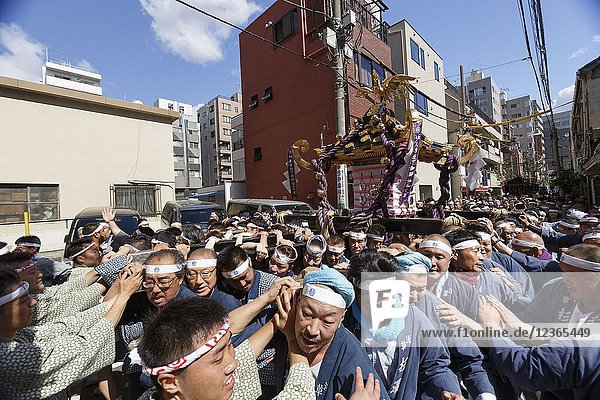 Participants carry a Mikoshi (portable shrine) during the Sanja Matsuri in Asakusa district on May 20  2018  Tokyo  Japan. The Sanja Matsuri is one of the largest Shinto festivals in Tokyo  and it is held in Tokyo's Asakusa district for three days around the third weekend of May. Large groups of people dressed up traditional clothes carry Mikoshi (sacred portable shrines) between the streets near to Sensoji Temple to bring blessing and fortune to the inhabitants of the neighboring community at Asakusa during the second and third day of the festival. The annual festival attracts millions of visitors every year.