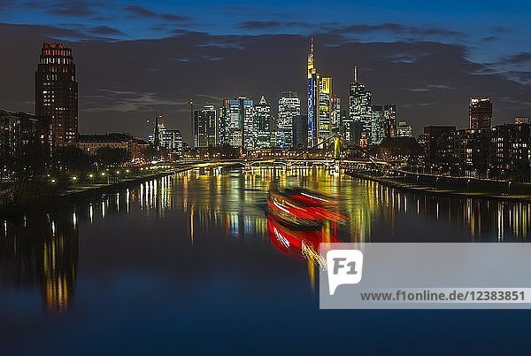 Trail of light from boat in front of skyline  blue hour  Osthafen  Frankfurt am Main  Hesse  Germany  Europe