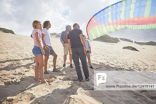 Paragliders with parachute on sunny beach