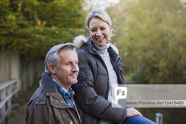 Happy mature couple in autumn park