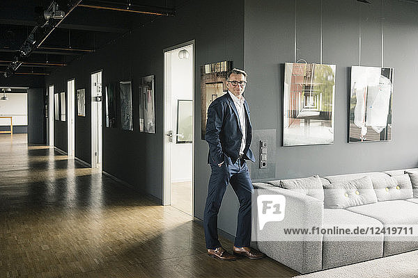 Portrait of confident mature businessman standing on office floor